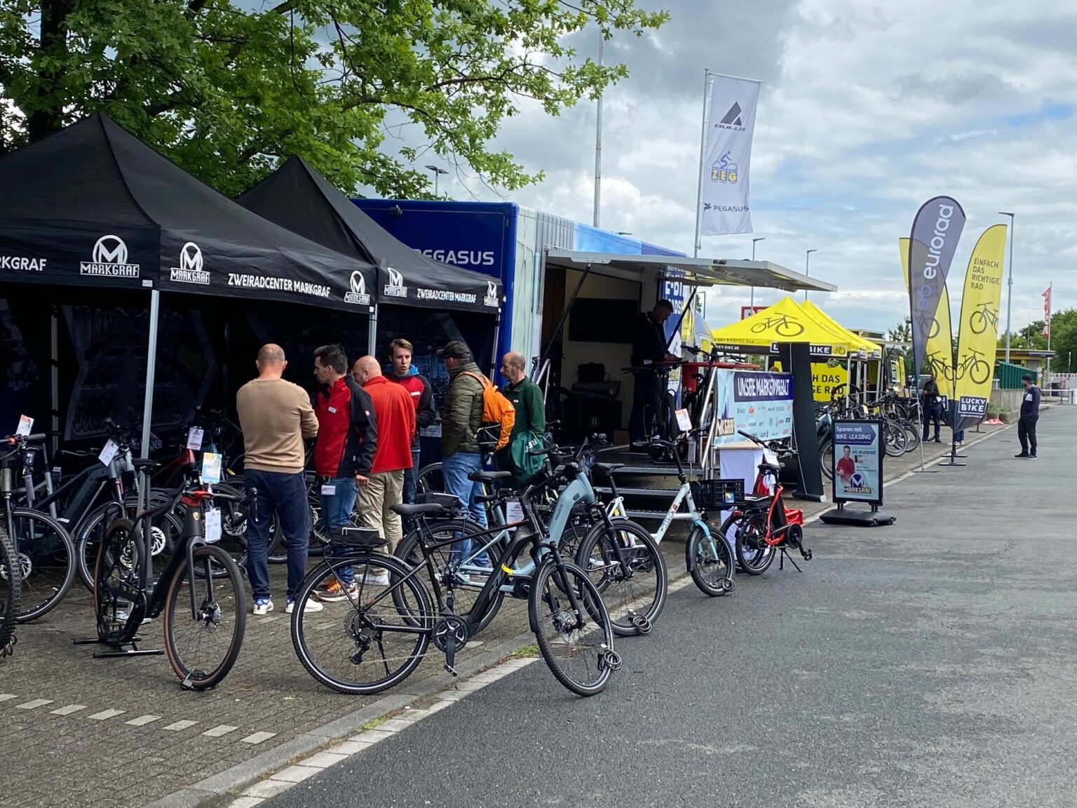 A gathering of cyclists at a festival or other outdoor event.